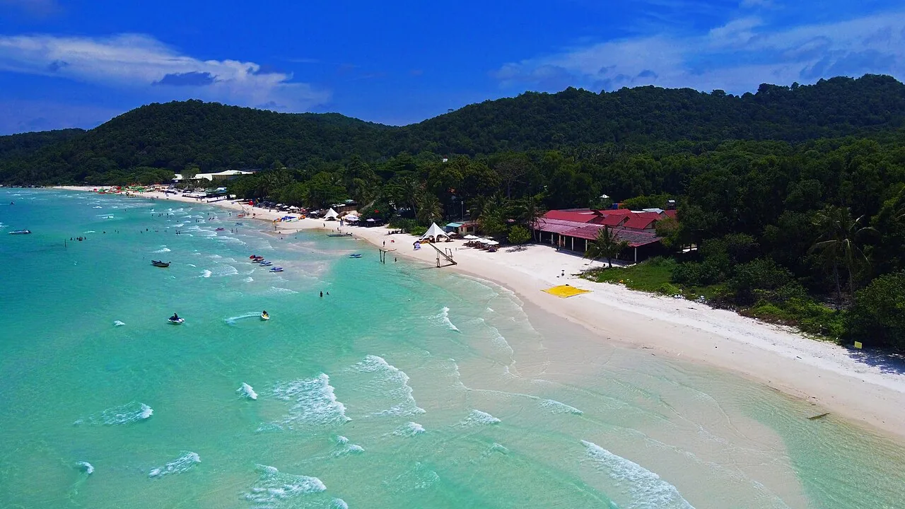 Aerial view of Bãi Sao beach, with white sand, shallow turquoise water and wooded hills on Phú Quốc